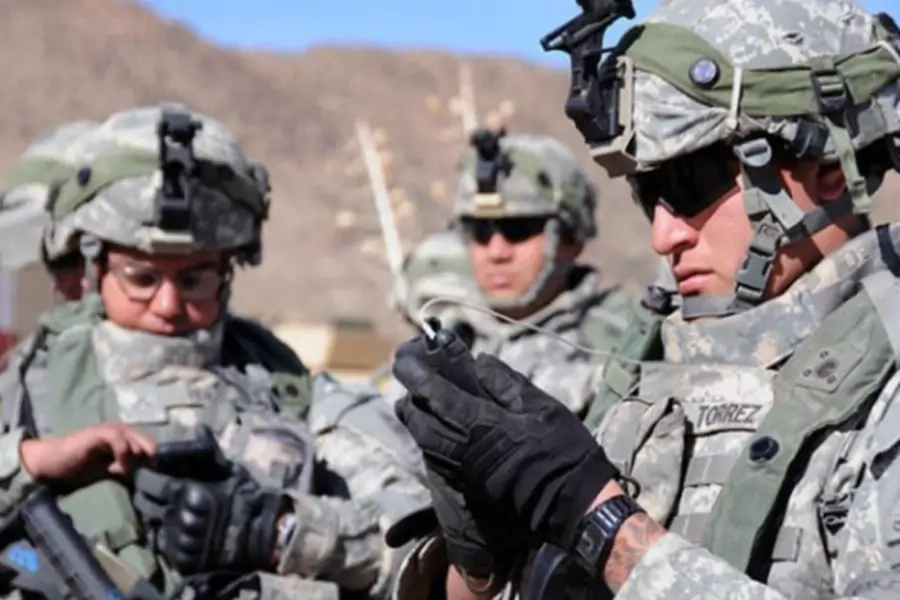 U.S. soldiers use their smartphones.