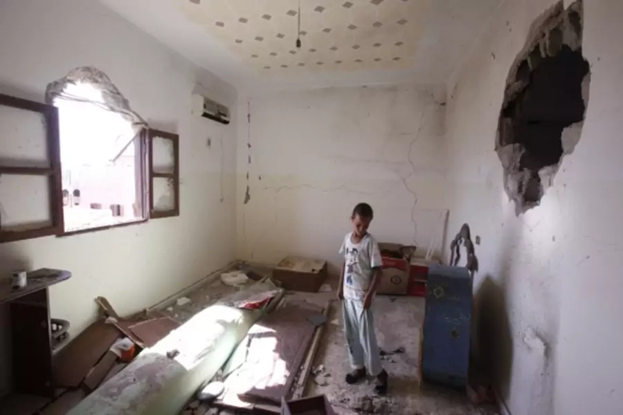 A child stands in her room after her family returned to their home in Sirte, Libya (Courtesy Reuters/Youssef Boudlal).