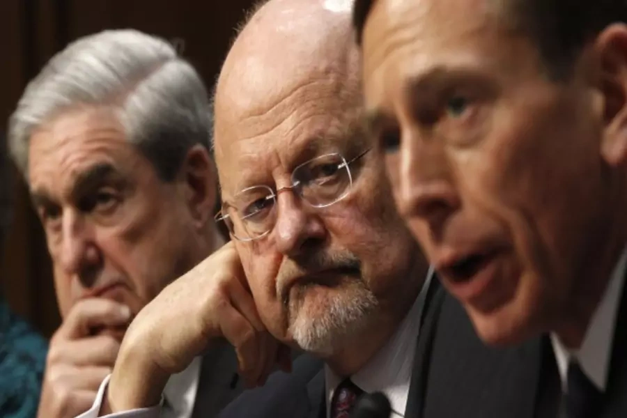 Director of National Intelligence James Clapper, flanked by FBI Director Robert Mueller and CIA Director David Petraeus as they testify before a Senate Select Intelligence hearing in Washington, DC, on January 31, 2012 (Courtesy Reuters/Kevin Lamarque).