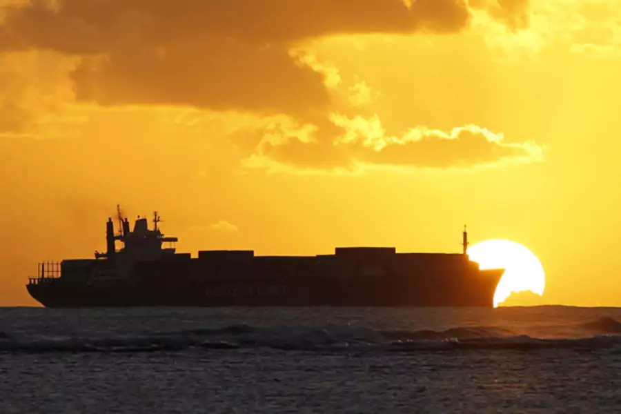 cargo ship at sunset; trade