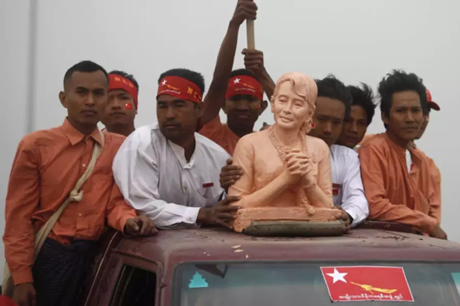 Supporters carry a bust of Myanmar pro-democracy leader Aung San Suu Kyi as she arrives in Mandalay March 3, 2012.
