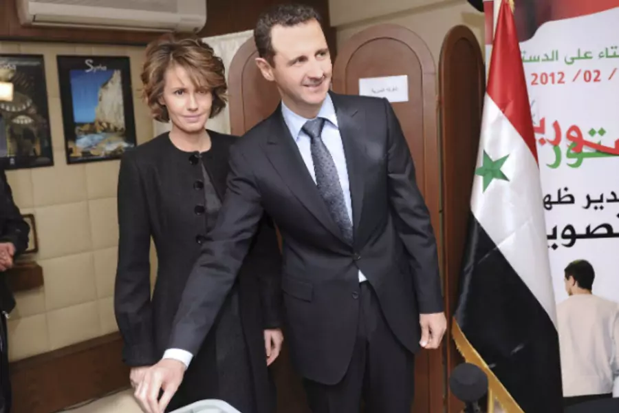 Syria's President Bashar al-Assad and his wife Asma vote during a referendum on a new constitution at a polling station in a Syrian TV station building in Damascus February 26, 2012. (Courtesy REUTERS/SANA)