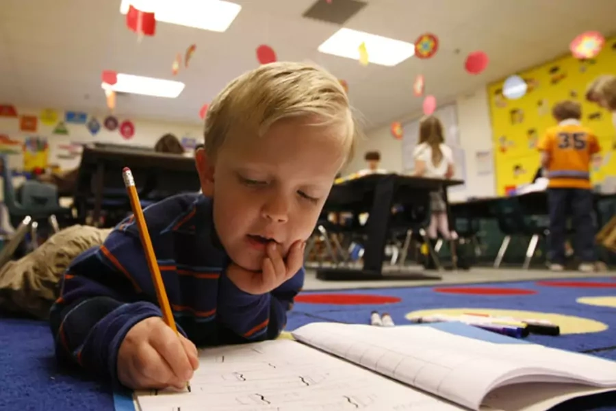 A first grader does his writing work on the floor of a classroom at an elementary school in Thornton, Colorado (Rick Wilking/Courtesy Reuters).