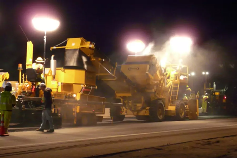 Employees of Pike Industries work at night paving a portion of Route 101 in Exeter, New Hampshire (Pike Industries Handout/Courtesy Reuters).
