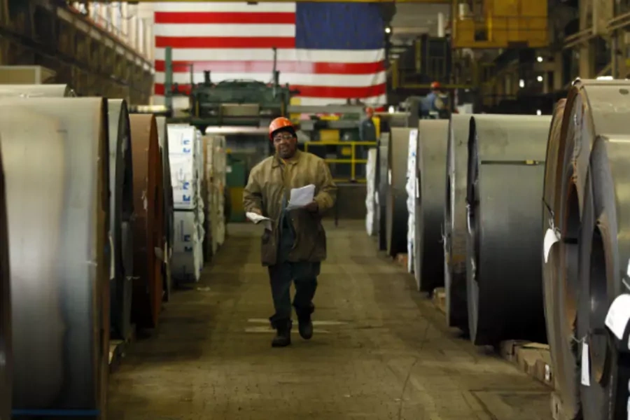 A Gregory Industries employee walks between rolls of steel before a Canton campaign event for Republican presidential candidate Mitt Romney (Brian Snyder/Courtesy Reuters).