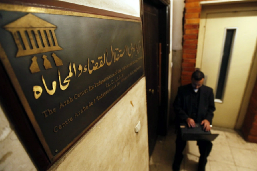 An Egyptian human rights worker sits outside a non-governmental organization in Cairo. (Courtesy Reuters)