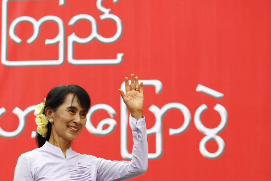 Myanmar pro-democracy leader Aung San Suu Kyi waves toward her supporters after finishing her address during the election campaign at Mon State in Myanmar.