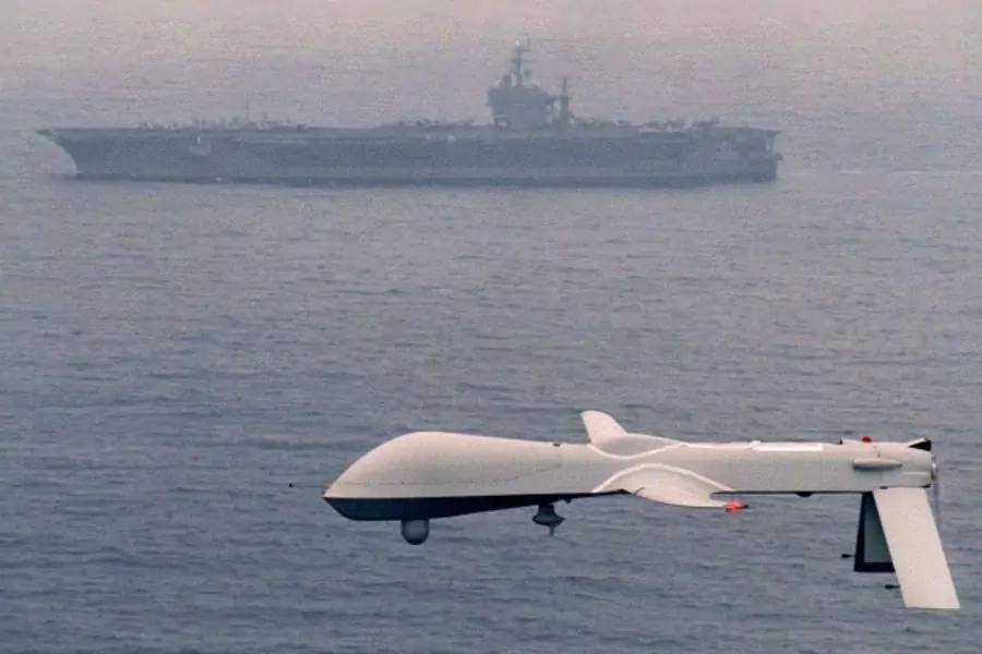 File photo of a Predator drone flying above the USS Carl Vinson (Courtesy Reuters/Handout).