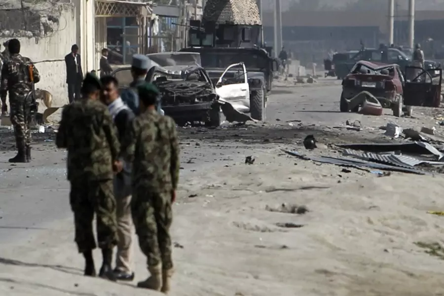 Afghan security forces members inspect the site of a car bomb attack in Kabul on May 2, 2012, hours after President Obama departed (Courtesy Reuters/Omar Sobhani).