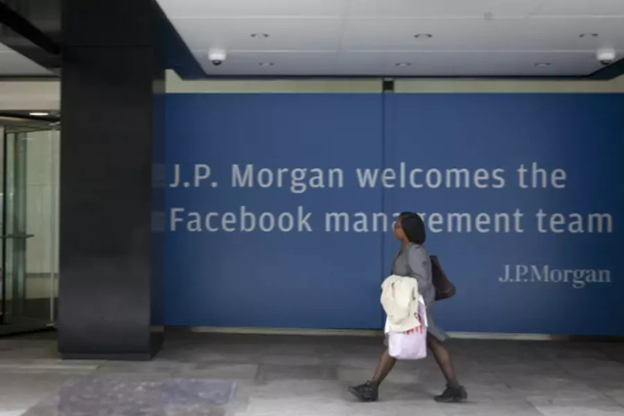 A woman walking near a J.P. Morgan sign welcoming Facebook's management team in preparation of its IPO. (Lee Celano/Courtesy Reuters)
