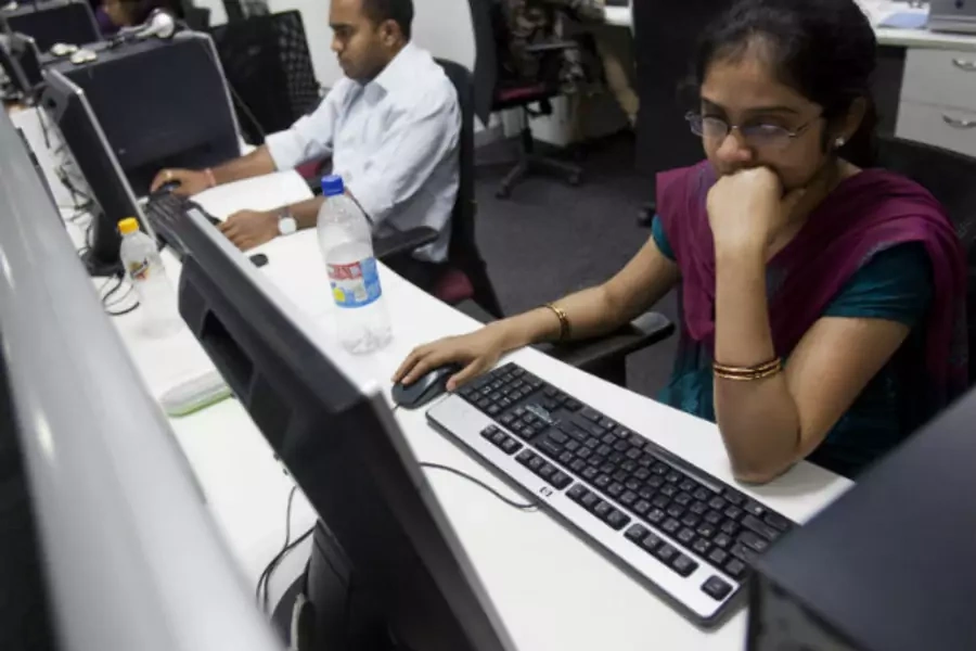 Workers are seen at their workstations on the floor of an outsourcing centre in Bangalore, February 29, 2012. (Vivek Prakash / Courtesy Reuters)