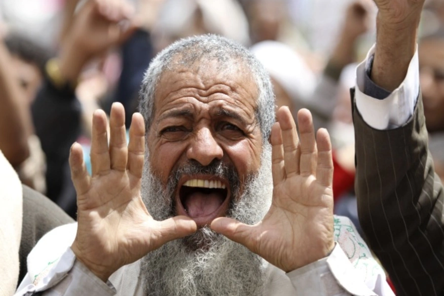 An anti-government protester shouts slogans during a rally in Sanaa, Yemen (Courtesy Reuters/Mohamed Al-Sayaghi).