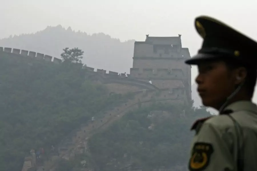 A policeman stands near the Great Wall on a hazy day in Juyongguan, China.