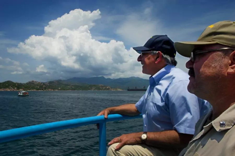 U.S. defense secretary Leon Panetta sits next to USNS Richard E. Byrd chief mate Fred Cullen as they take a water taxi to the ship in Cam Ranh Bay.