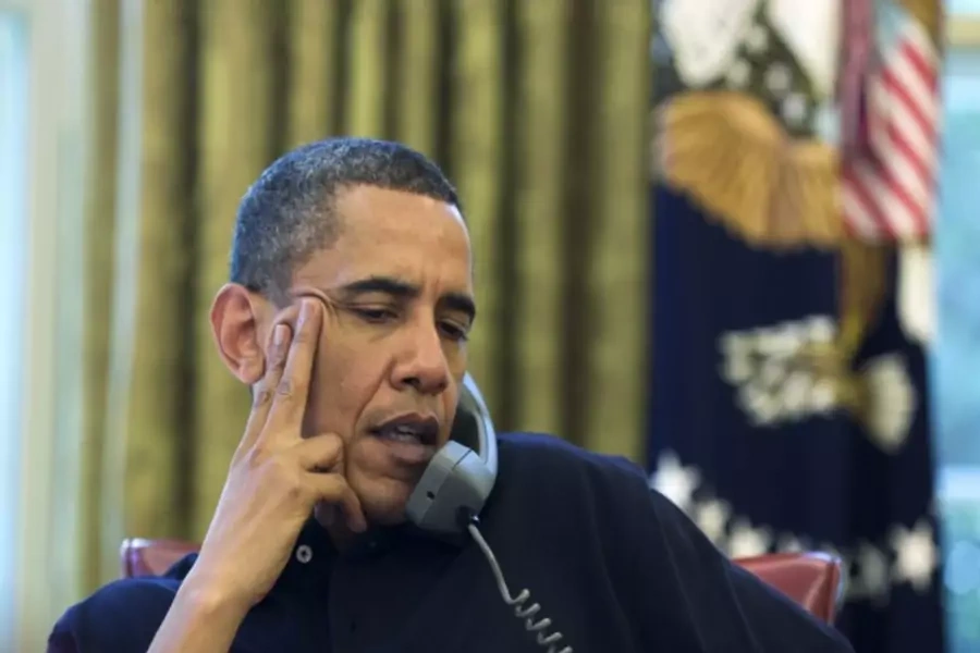 U.S. president Barack Obama on the phone in the Oval Office in Washington, DC (Handout/Courtesy Reuters).