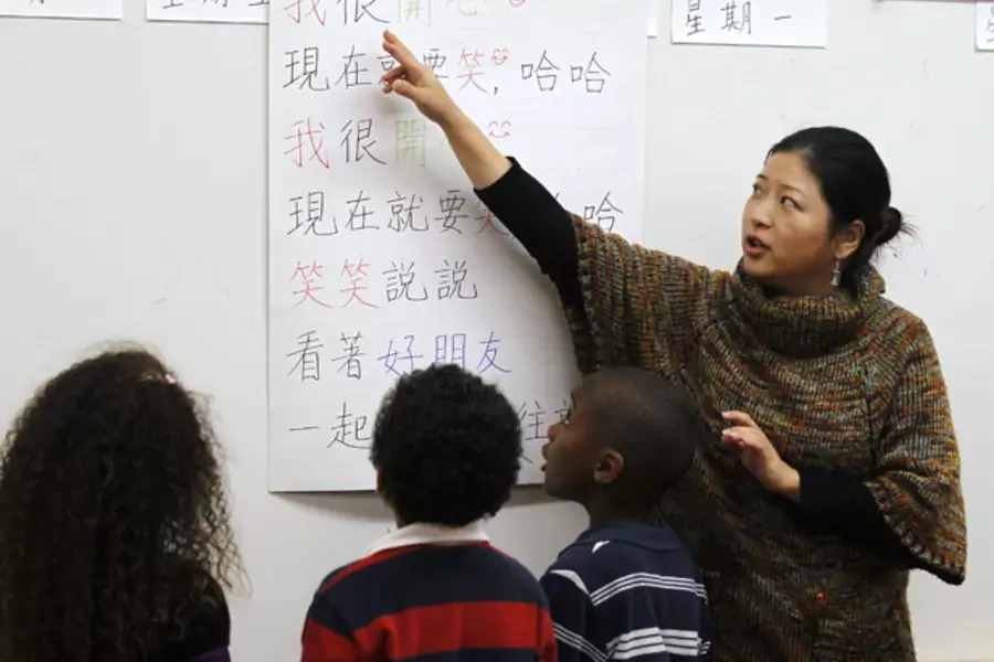 Teacher Kennis Wong points to Chinese characters on a board at Broadway Elementary School in Los Angeles, California (Lucy Nicholson/Courtesy Reuters).