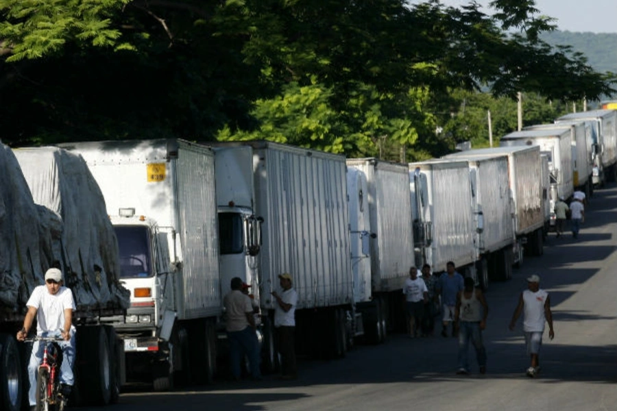 Container trucks stand in line as they are stopped on border between El Salvador and Honduras