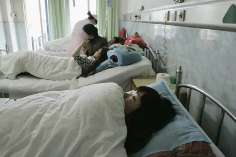 A young Chinese surrogate mother in the maternity ward of Guangzhou's Taihe Hospital, where she said she was forced into an abortion by the city's family planning officials, on April 30, 2009.