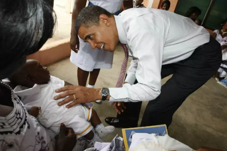 President Barack Obama greets a baby as he visits a hospital in Accra, Ghana on July 11, 2009 (Jason Reed/Courtesy Reuters).