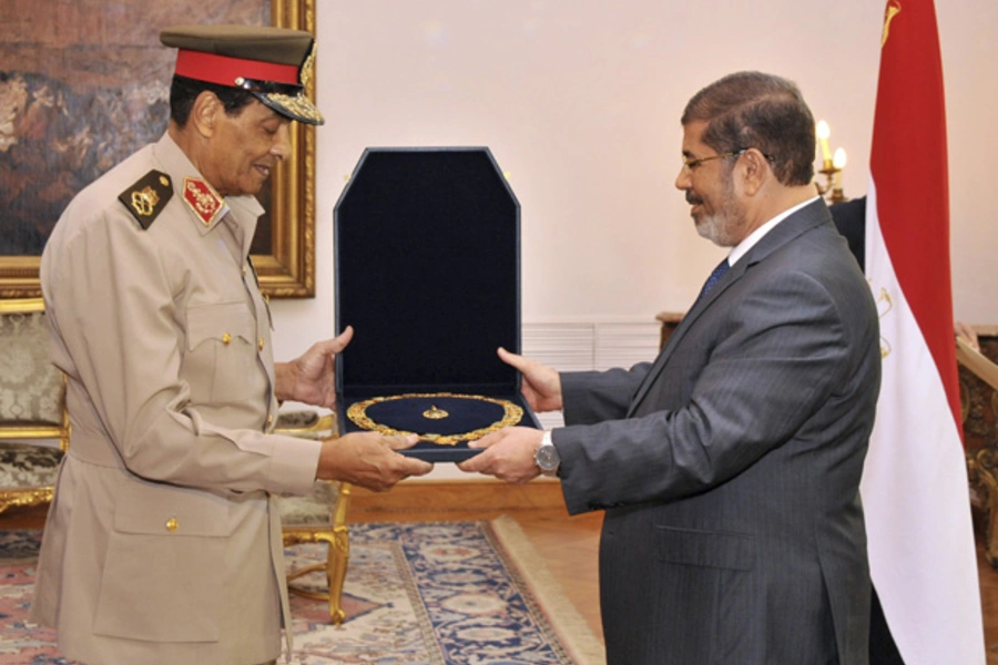 Former Egyptian defense minister Field Marshal Hussein Tantawi receives a medal from Egyptian president Mohammed Morsi at the Presidential Palace in Cairo. (Egyptian Presidency/Handout/courtesy Reuters)