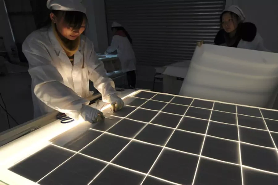 Employees work on a solar panel production line at a solar company workshop in Hefei, China (Stringer/Courtesy Reuters).