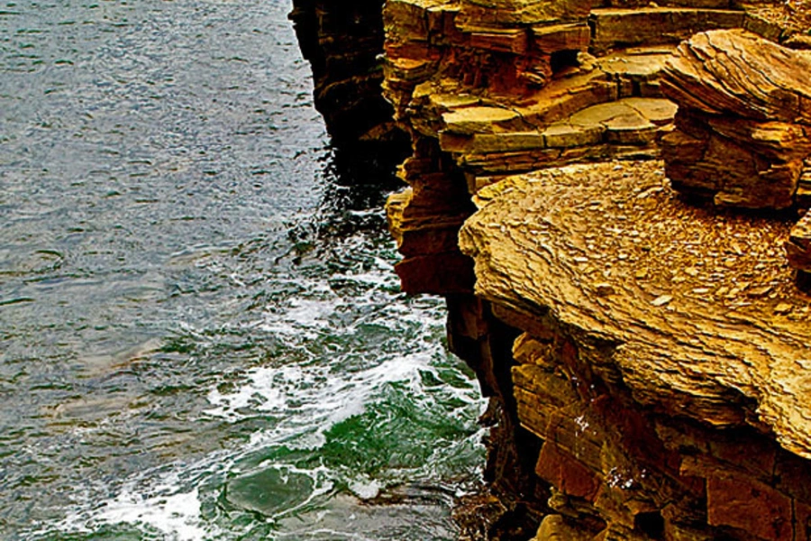 Cragged bluffs rise from the sea. (Courtesy Darren Harmon).