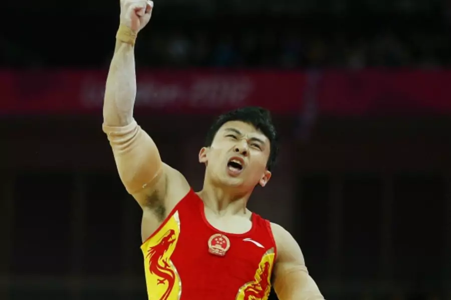 China's Feng Zhe, the eventual gold medal winner, reacts after competing in the men's gymnastics parallel bars final during the London 2012 Olympic Games on August 7, 2012.