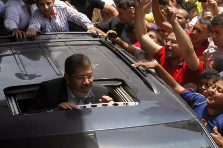 Presidential candidate Mohamed Morsy of the Muslim Brotherhood greets a crowd outside a mosque after attending Friday Prayers in Cairo, June 15, 2012. (Courtesy REUTERS/Steve Crisp)