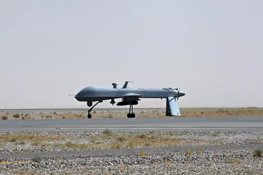 An armed U.S. Predator drone waits on the tarmac in Kandahar, Afghanistan (Pool New/Courtesy Reuters).