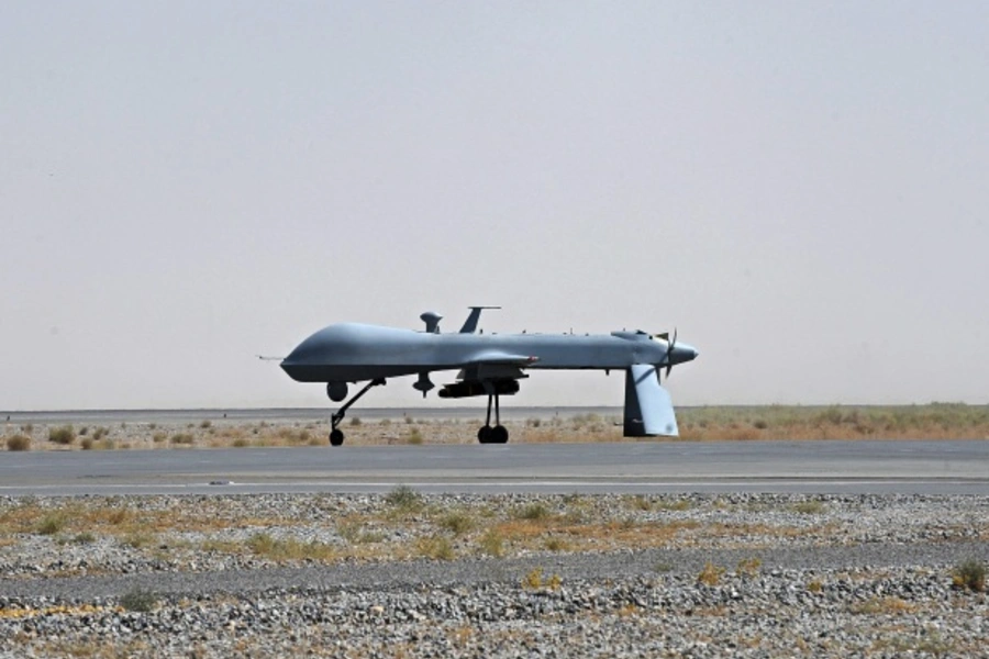 An armed U.S. Predator drone waits on the tarmac in Kandahar, Afghanistan (Pool New/Courtesy Reuters).