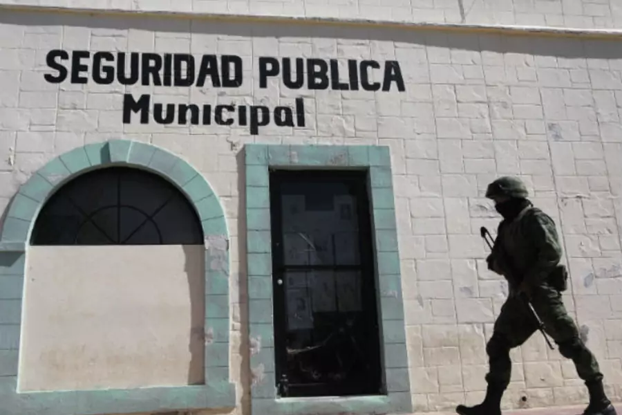 A soldier walks past the police headquarters where Marisol Valles Garcia used to work as the police chief in Praxedis G. Guerrero (Stringer/Courtesy Reuters).