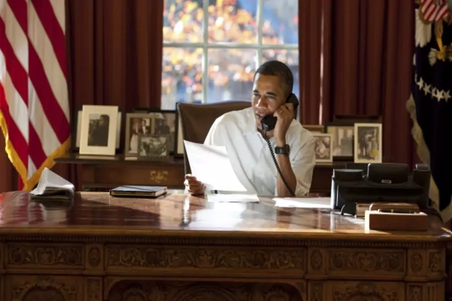President Obama makes calls in the Oval Office in Washington, DC (Handout/Courtesy Reuters).
