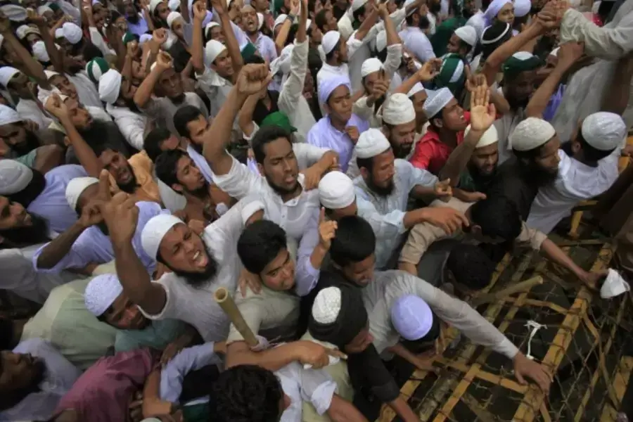 Bangladeshi Muslims attempt to break a police barricade during a protest in Dhaka on September 14, 2012 (Andrew Biraj/Courtesy Reuters).