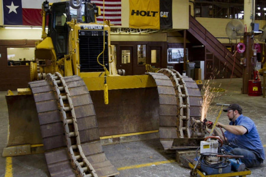 Michael Hill works on the track of a Caterpillar bulldozer at Holt Caterpillar, the largest Caterpillar dealer in the United States, in San Antonio, Texas on March 19, 2012 (Richard Carson/Courtesy Reuters).