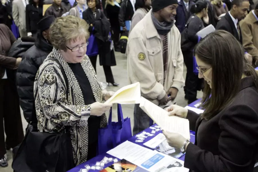 Job seekers line up to speak to prospective employers during a job fair in Detroit, Michigan (Rebecca Cook/Courtesy Reuters).
