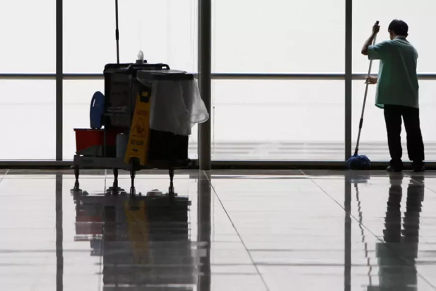A cleaner mops the floor of an empty hall at a convention centre in Singapore (Vivek Prakash/Courtesy Reuters).