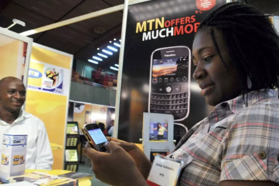 A delegate checks a Blackberry handset at an exhibition stand during the West & Central Africa Com conference in Nigeria's capital Abuja on June 18, 2009 (Afolabi Sotunde/Courtesy Reuters).