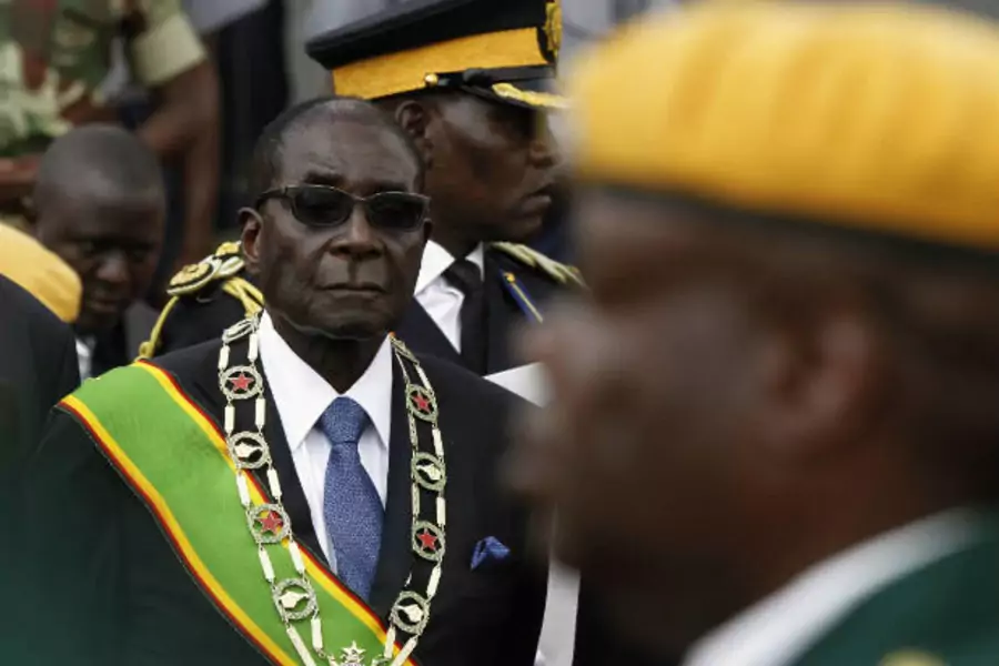 President of Zimbabwe Robert Mugabe (L) attends a commemorative event for National Heroes' Day at the National Heroes Acre in Harare on August 13, 2012 (Philimon Bulawayo/Courtesy Reuters).
