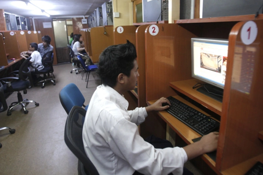 A man looks at YouTube at an Internet cafe in Yangon, Myanmar.
