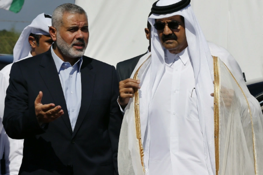 Hamas Prime Minister Ismail Haniyeh (L) and the Emir of Qatar Sheikh Hamad bin Khalifa al-Thani arrive at a cornerstone laying... a new residential neighborhood in Khan Younis in the southern Gaza Strip October 23, 2012. (Courtesy REUTERS/Mohammed Salem).