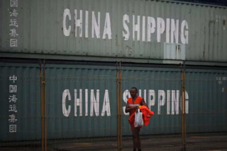 Worker walks past by containers from China Shipping company at Brazil's main ocean port of Santos city