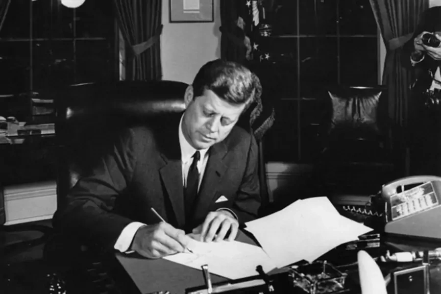 President John F. Kennedy signs Proclamation 3504 authorizing the quarantine of Cuba on October 23, 1962. (Abbie Rowe. White House Photographs. John F. Kennedy Presidential Library and Museum, Boston)