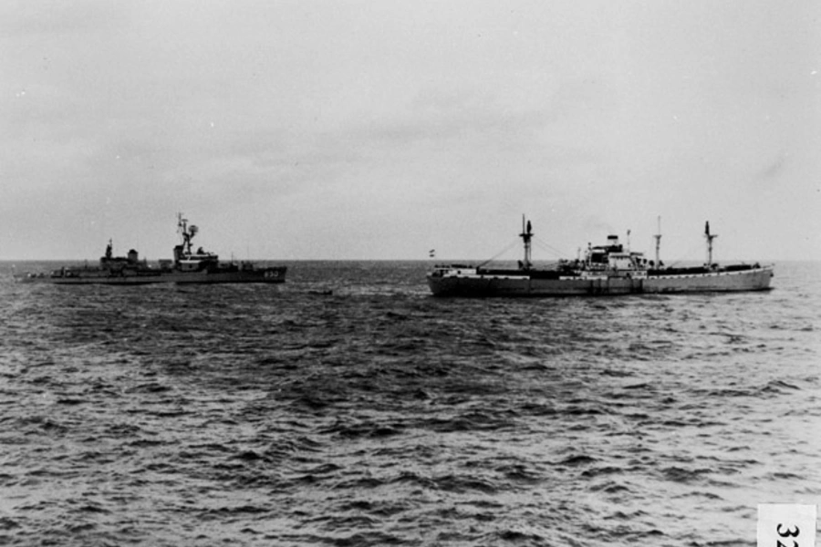 The U.S. destroyer Joseph P. Kennedy stops, boards, and inspects the Marucla, a dry-cargo ship of Lebanese registry under Soviet charter to Cuba. (Dino A. Brugioni Collection, The National Security Archive, Washington, DC)