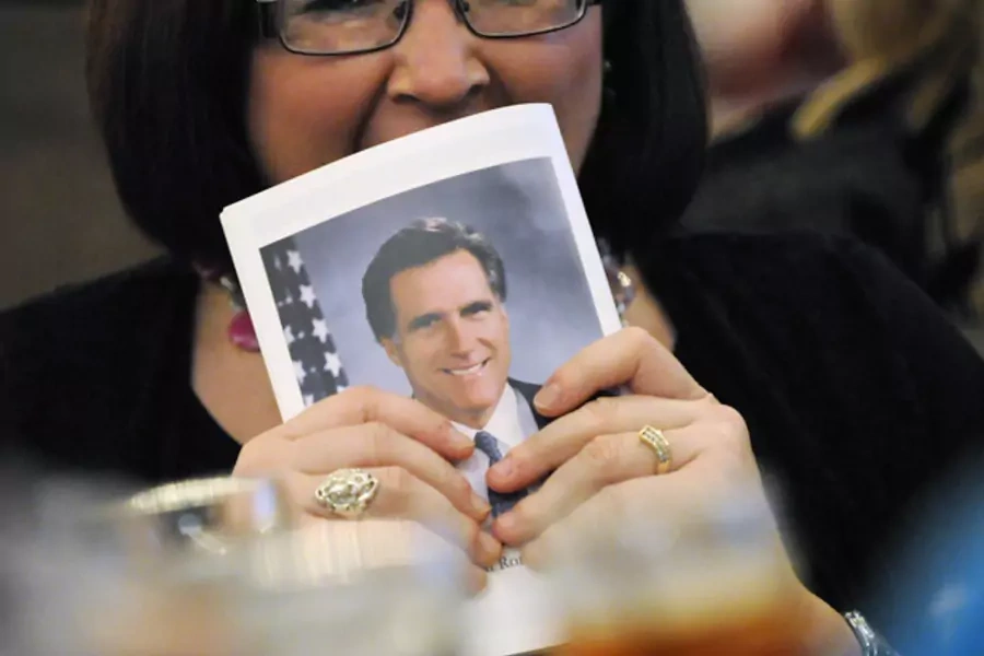 A member of the audience yawns behind a copy of her program at the Franklin County Lincoln Day Dinner, where U.S. Republican presidential candidate Mitt Romney delivered remarks (Jonathan Ernst/Courtesy Reuters).