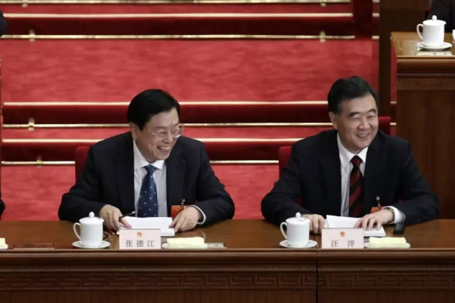 China's Guangdong Province Party Secretary Wang Yang (R) smiles next to Vice Premier Zhang Dejiang at the second plenary meeting of the National People's Congress in the Great Hall of the People in Beijing on March 8, 2012.