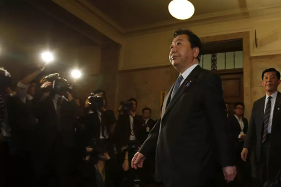 Japan's prime minister Yoshihiko Noda arrives for a lower house plenary session at the parliament in Tokyo November 15, 2012