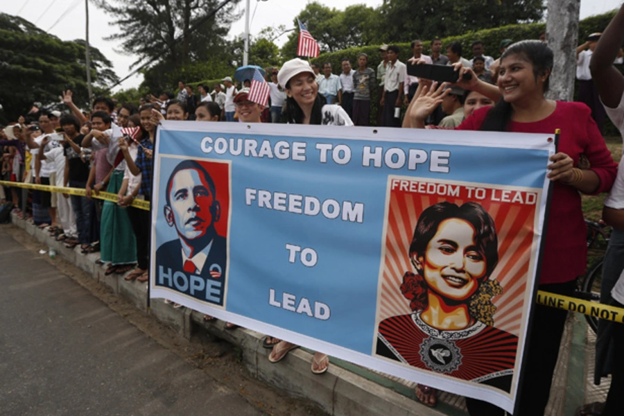 Crowds line a street outside the home of Myanmar's opposition leader Aung San Suu Kyi as U.S. president Barack Obama arrives to meet her in Yangon November 19, 2012.
