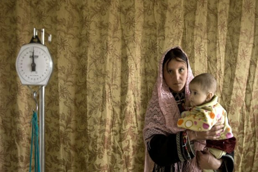 A mother holds her child as she visits a health clinic in Eshkashem district of Badakhshan province in Afghanistan (Ahmad Masood/Courtesy Reuters).