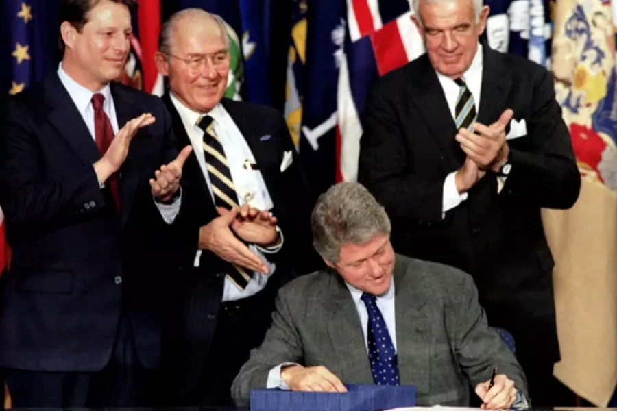 President Clinton signs the North American Free Trade Agreement (NAFTA) into law on December 8, 1993 (Mike Theiler/Courtesy Reuters).