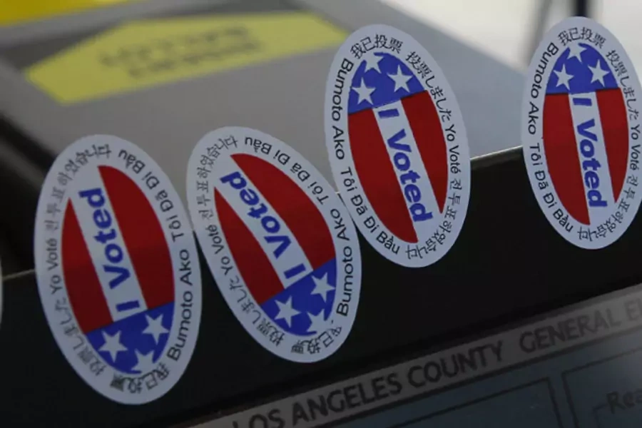 Stickers stating "I Voted" in several languages are affixed to a ballot intake machine during the 2012 national election (Fred Prouser/Courtesy Reuters).